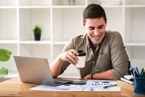 A happy accountant with a clean desk, captioned, "When OneUp Networks handles your IT, and you actually have time to enjoy your coffee.